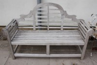 Lot 696 - A teak garden bench in the style of Edwin Lutyens