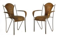 Lot 554 - A pair of wrought iron armchairs
