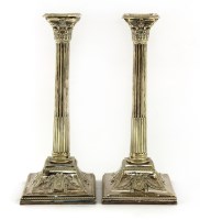 Lot 384 - A pair of silver-plated Corinthian column candlesticks