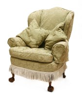 Lot 243 - A wing armchair
