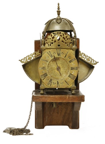 Lot 417 - A brass winged lantern clock