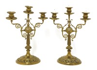 Lot 489 - A pair of brass three-sconce candelabra