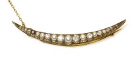 Lot 317 - A gold diamond and split pearl open crescent brooch