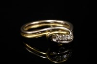 Lot 585 - An 18ct yellow and white gold three stone diamond ring