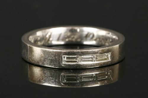 Lot 15 - An 18ct white gold three stone baguette cut diamond wedding ring