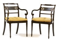 Lot 629 - A pair of Georgian ebonised and gilded open armchairs