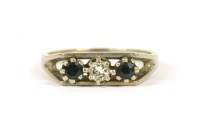 Lot 52 - An 18ct white gold three stone diamond and sapphire ring
