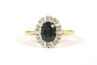 Lot 58 - An 18ct gold oval cut sapphire and diamond cluster ring