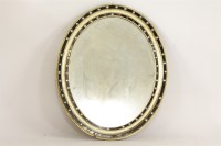 Lot 690A - An Irish ebonised and gilt oval mirror