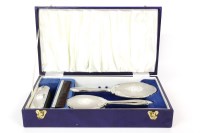 Lot 95 - A modern cased four piece silver backed dressing table set