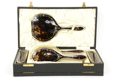 Lot 94 - A tortoiseshell and silver five piece dressing table set