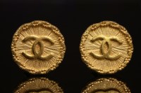 Lot 527 - A pair of Chanel gold-plated circular monogrammed clip-on earrings