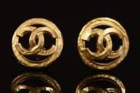 Lot 523 - A pair of Chanel gold-plated pierced monogrammed clip-on earrings