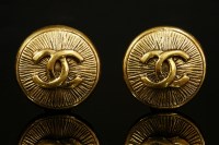 Lot 525 - A pair of Chanel gold-plated circular monogrammed clip earrings
