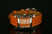 Lot 469 - A ladies stainless steel Hermès 'Heure H' quartz strap watch