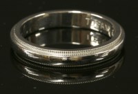 Lot 412 - A platinum wedding ring by Tiffany