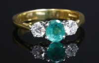 Lot 258 - An 18ct gold three stone emerald and diamond ring