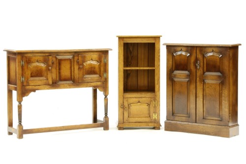 Lot 466 - A reproduction panelled oak cabinet