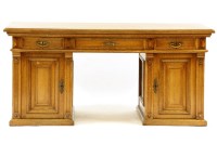Lot 475 - An early 20th century Continental light oak pedestal desk