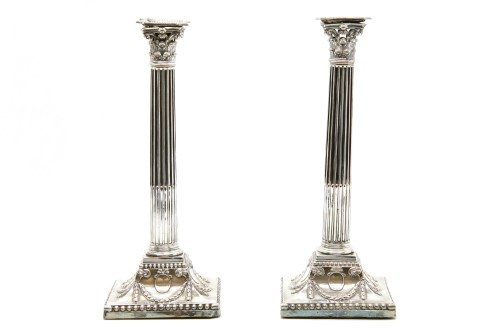 Lot 106 - A pair of silver plated corinthian column candle sticks