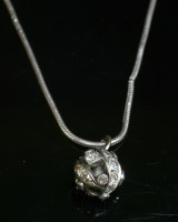 Lot 146 - A diamond set pierced bead pendant