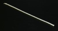 Lot 427 - A white gold diamond set line bracelet
