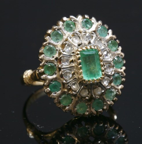 Lot 219 - An emerald and diamond oval cluster ring