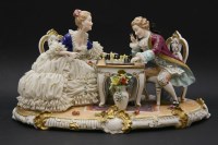 Lot 187 - A large 20th century Continental porcelain group of a lady and gentleman seated at a table playing chess