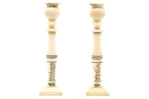 Lot 106 - A pair of Indian ivory candlesticks
