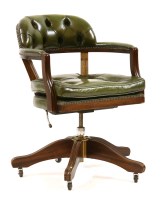 Lot 523 - A green leather swivel office chair