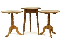 Lot 453 - A pair of pine occasional tables each on turned support and tripod base