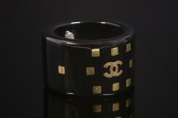 Lot 539 - A Chanel black resin band ring
