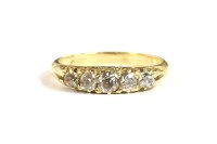 Lot 85 - A five stone graduated diamond carved head ring
