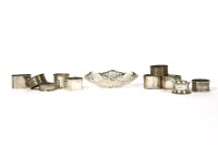 Lot 178 - A collection of ten various silver napkin rings together with a shaped and pierced silver bonbon dish by A Taite & Sons Ltd