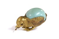 Lot 197 - A gilt metal chick tape measure with turquoise egg. 3cm high
