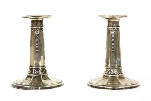 Lot 247 - A pair of silver dwarf candlesticks