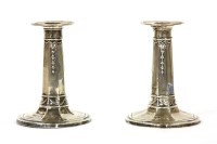 Lot 247 - A pair of silver dwarf candlesticks