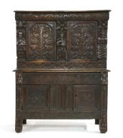 Lot 593 - A carved oak cupboard