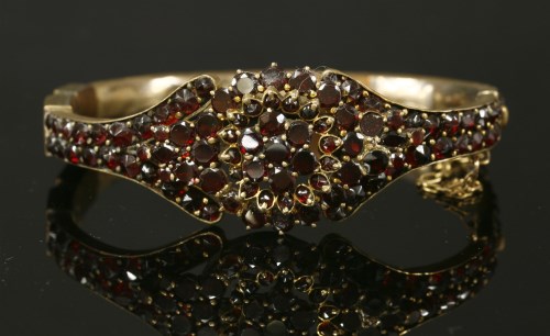 Lot 108 - A Victorian bohemian garnet gilt metal hinged bangle