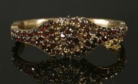 Lot 108 - A Victorian bohemian garnet gilt metal hinged bangle
