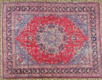 Lot 586 - A large blue ground carpet with scrolling foliate field within banded border