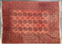 Lot 549A - A large Middle Eastern red ground carpet with elephants foot lozenges