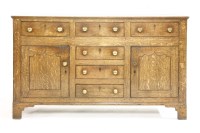 Lot 547 - An early 19th century oak sideboard