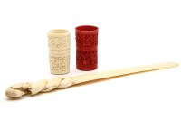 Lot 187 - A carved ivory bird paper knife and two Chinese carved ivory dice shakers. 6.5cm tall