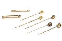 Lot 103 - A collection of gold stick pins and two bar brooches