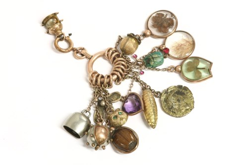 Lot 128 - A rose gold bolt ring with thirteen assorted charms on chains