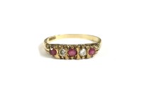 Lot 88 - A 9ct gold carved head five stone graduated ruby and diamond ring