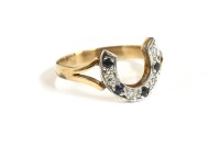 Lot 90 - A gold diamond and sapphire horseshoe ring