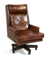 Lot 588 - A brown leather swivel office chair