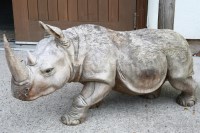 Lot 663 - A carved hardwood rhino